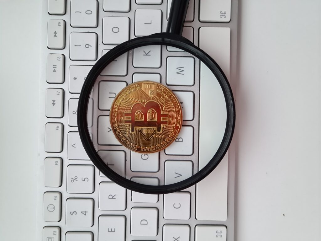 bitcoin-coin-magnifying-glass-computer-keyboard
